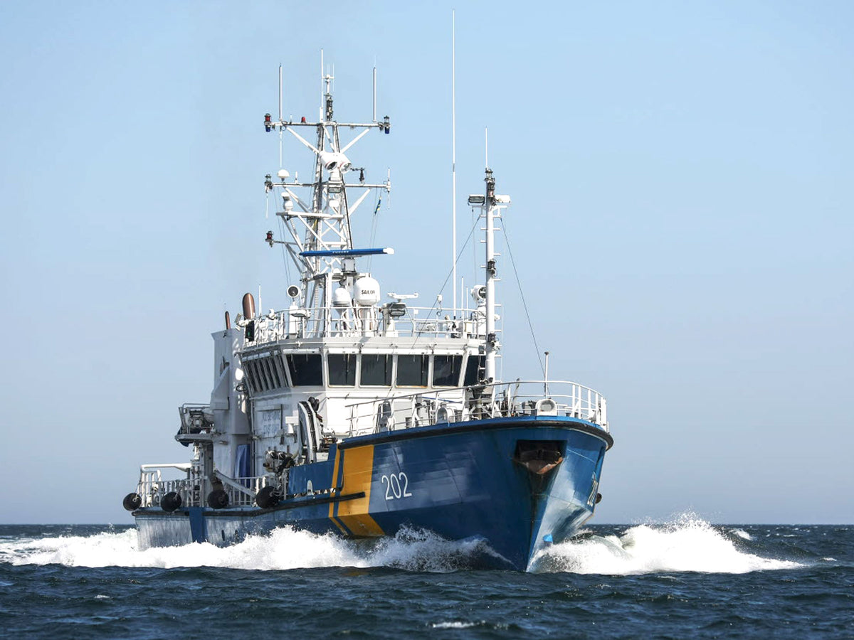 A blue and white ship with yellow accents, marked with the number 202, making way through open water under a clear blue sky.